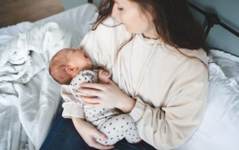 Crying,Baby,Girl,On,Mother,Hands,With,Colic,Stomach,Ache